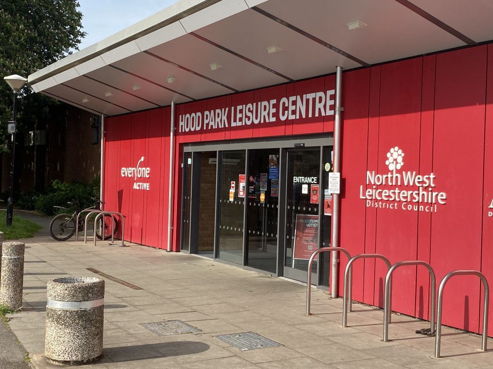 A red building with a sign that says hood park leisure centre