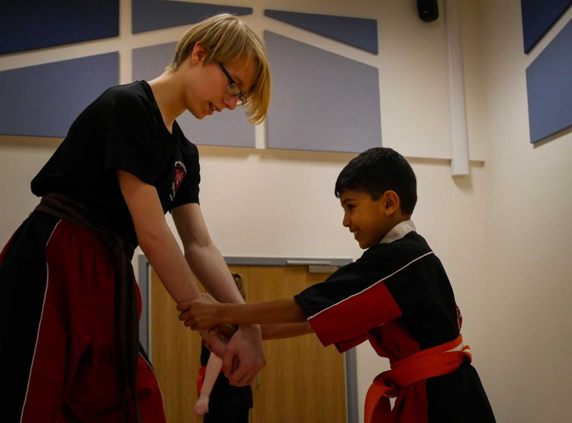 A man and a boy are holding hands in a room