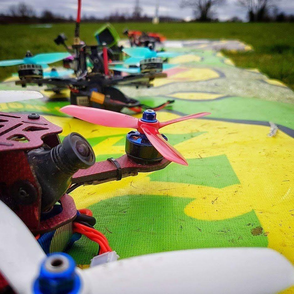 A group of drones are sitting on top of a colorful surface.