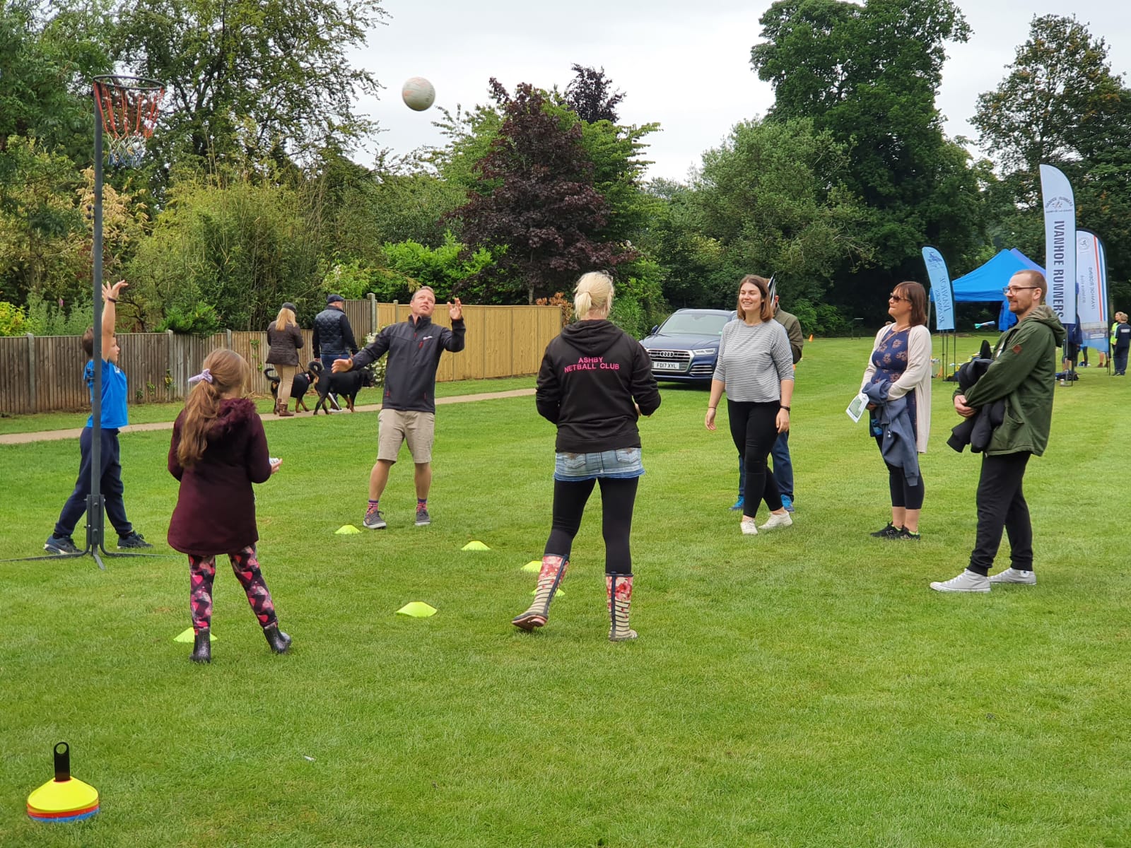 A group of people are playing a game of basketball in a park.