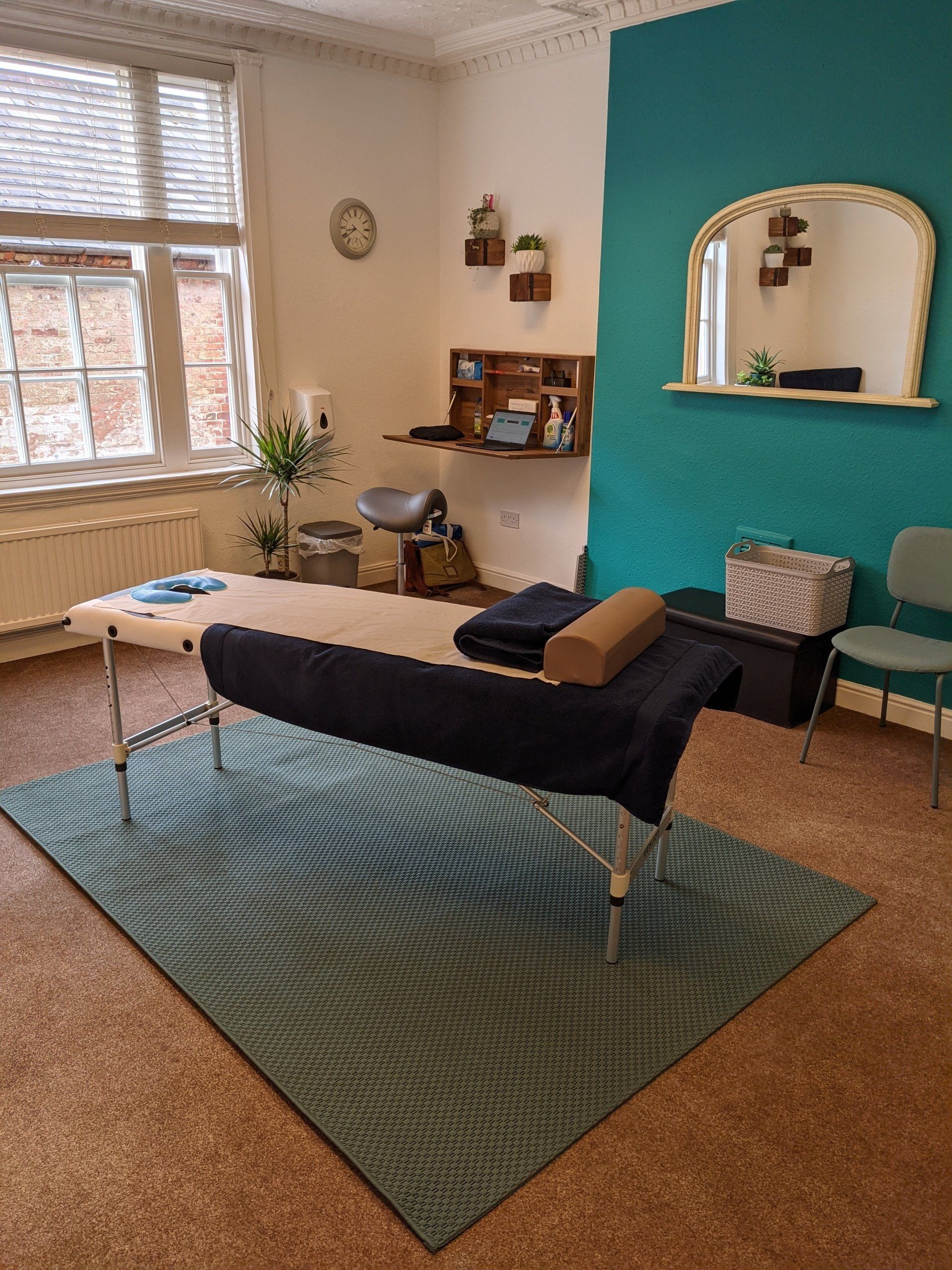 A room with a table and chairs and a blue wall.