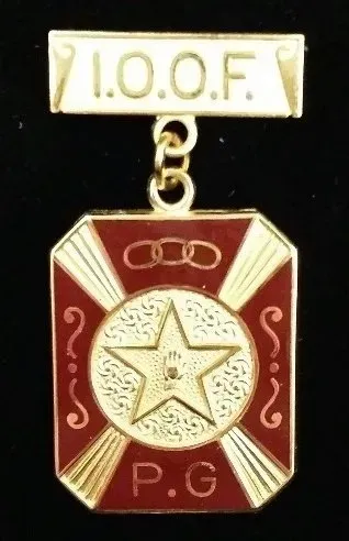 A red and gold badge with a star and the word p.g. on it
