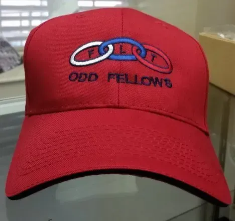 A red hat with odd fellows embroidered on it
