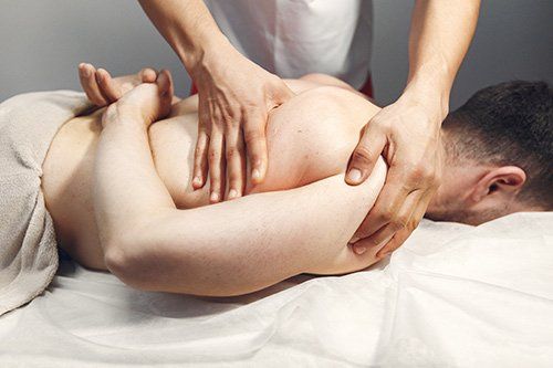 A man is getting a massage from a woman in a spa.