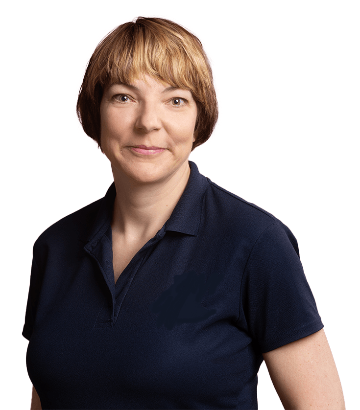 A woman in a blue shirt is smiling for the camera