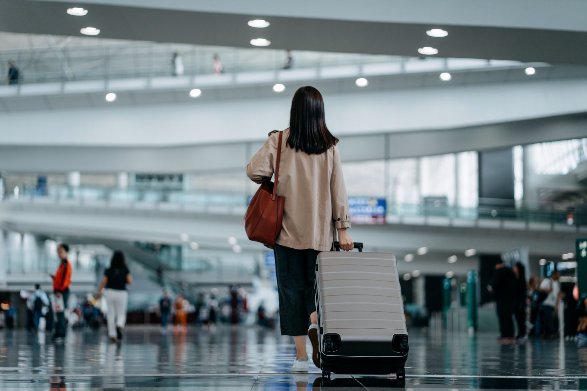 Woman at airport with Tom Saal International Travel Insurance Illinois.