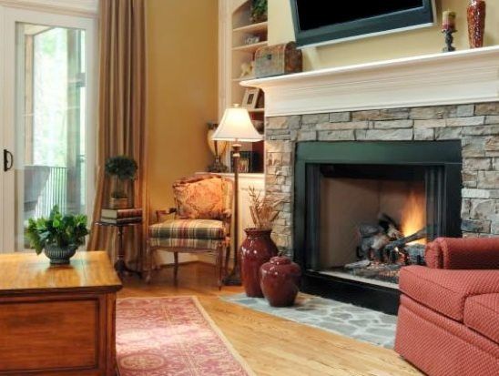 A living room with a fireplace and a flat screen tv