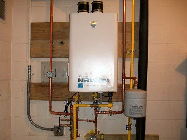 A navien water heater is mounted to a wall
