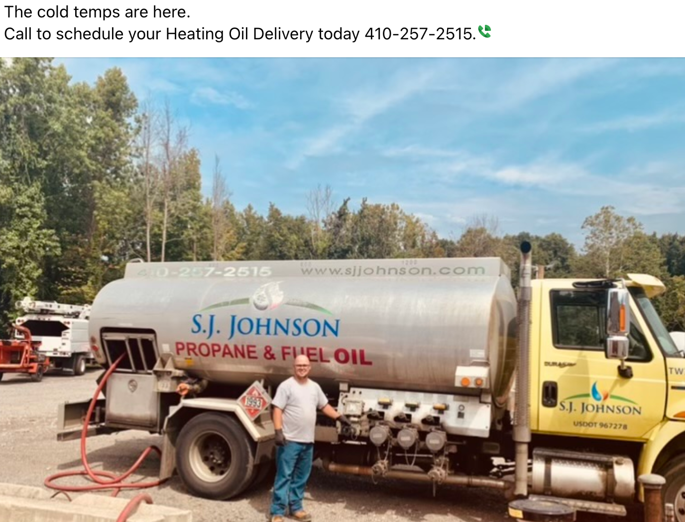 A man is standing in front of a propane and fuel oil truck