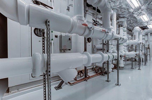 A row of white pipes are lined up in a room.