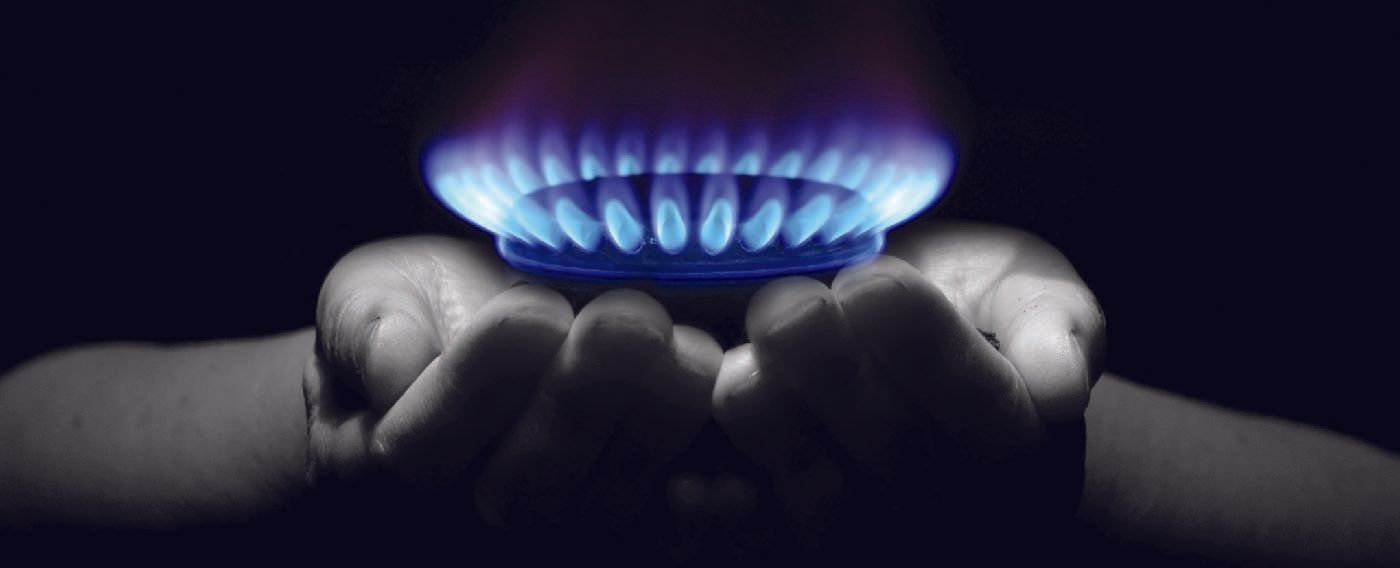 A person is holding a gas burner in their hands.