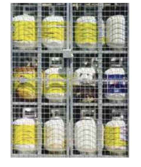 A bunch of bottles are sitting in a cage.