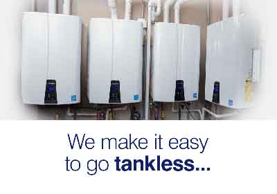 A row of white water heaters hanging on a wall.