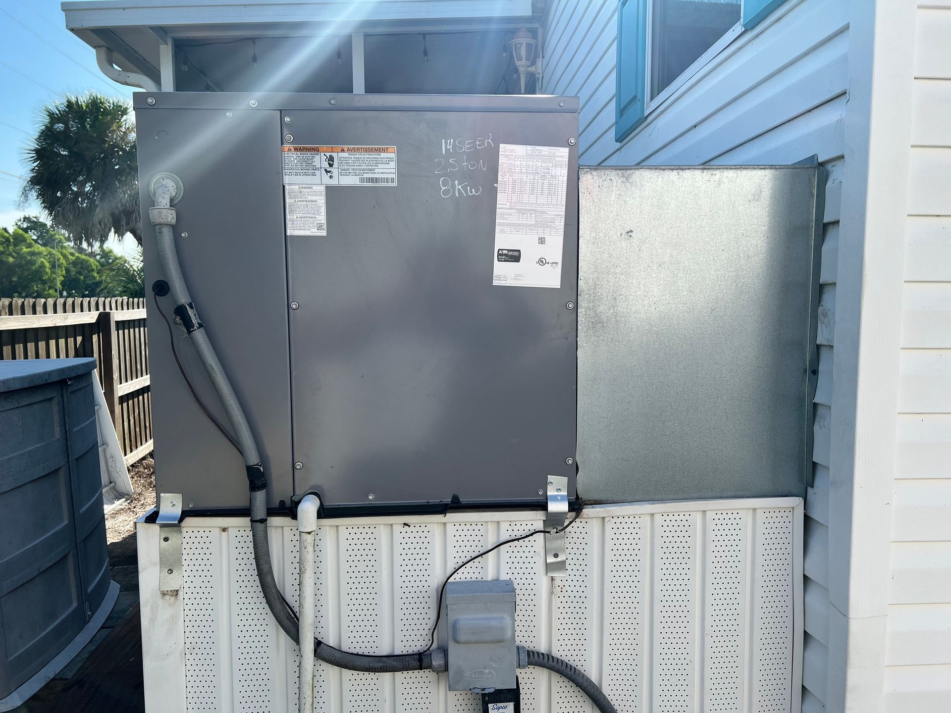 a large gray box is attached to the side of a house .