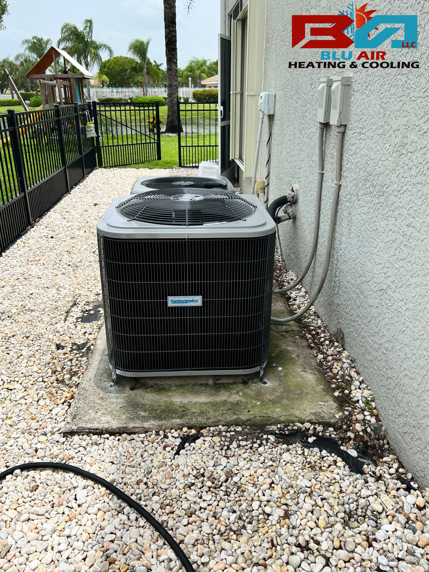 a couple of air conditioners are sitting on the side of a building .