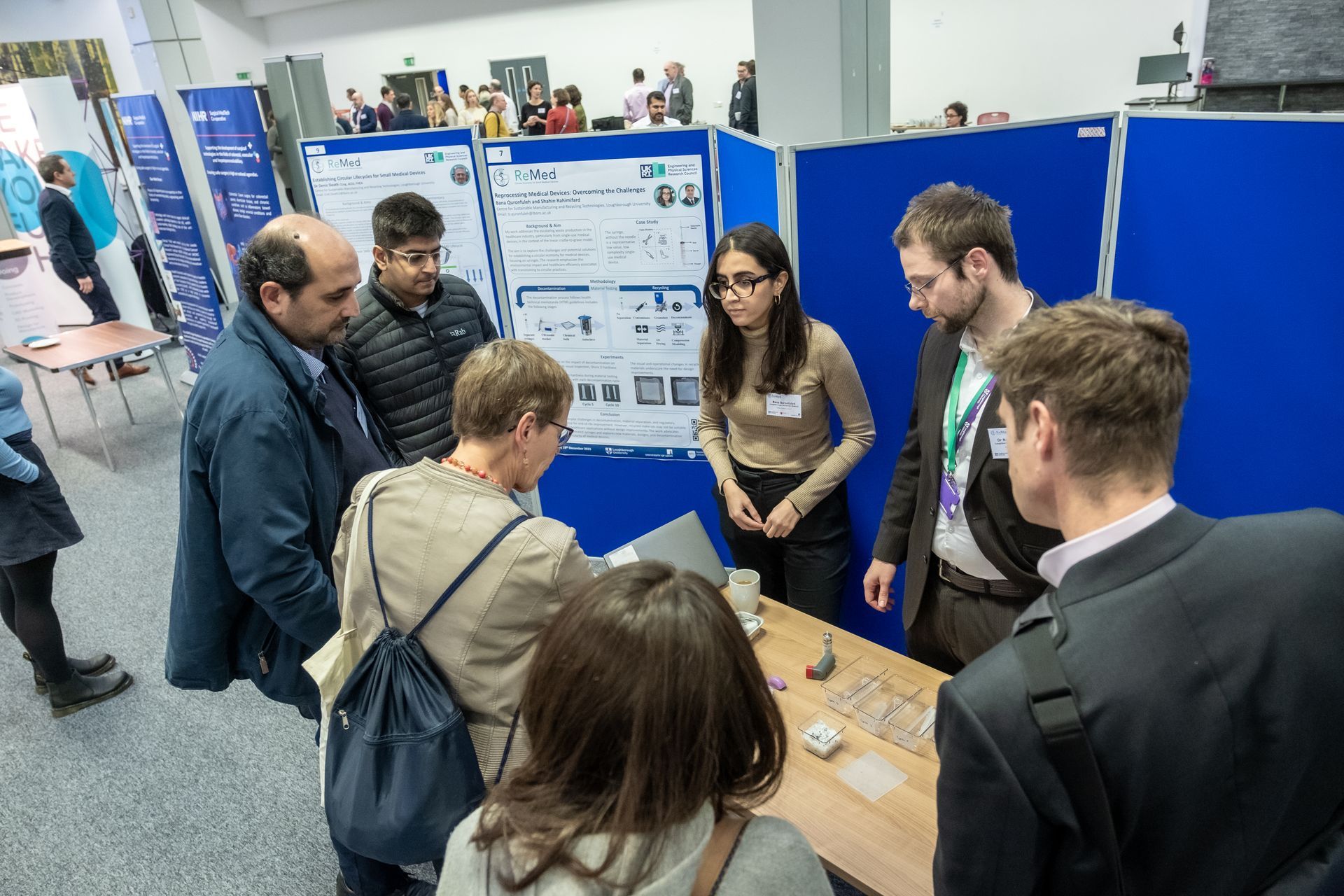 Photo of ReMed researchers and delegates engaging during the poster session
