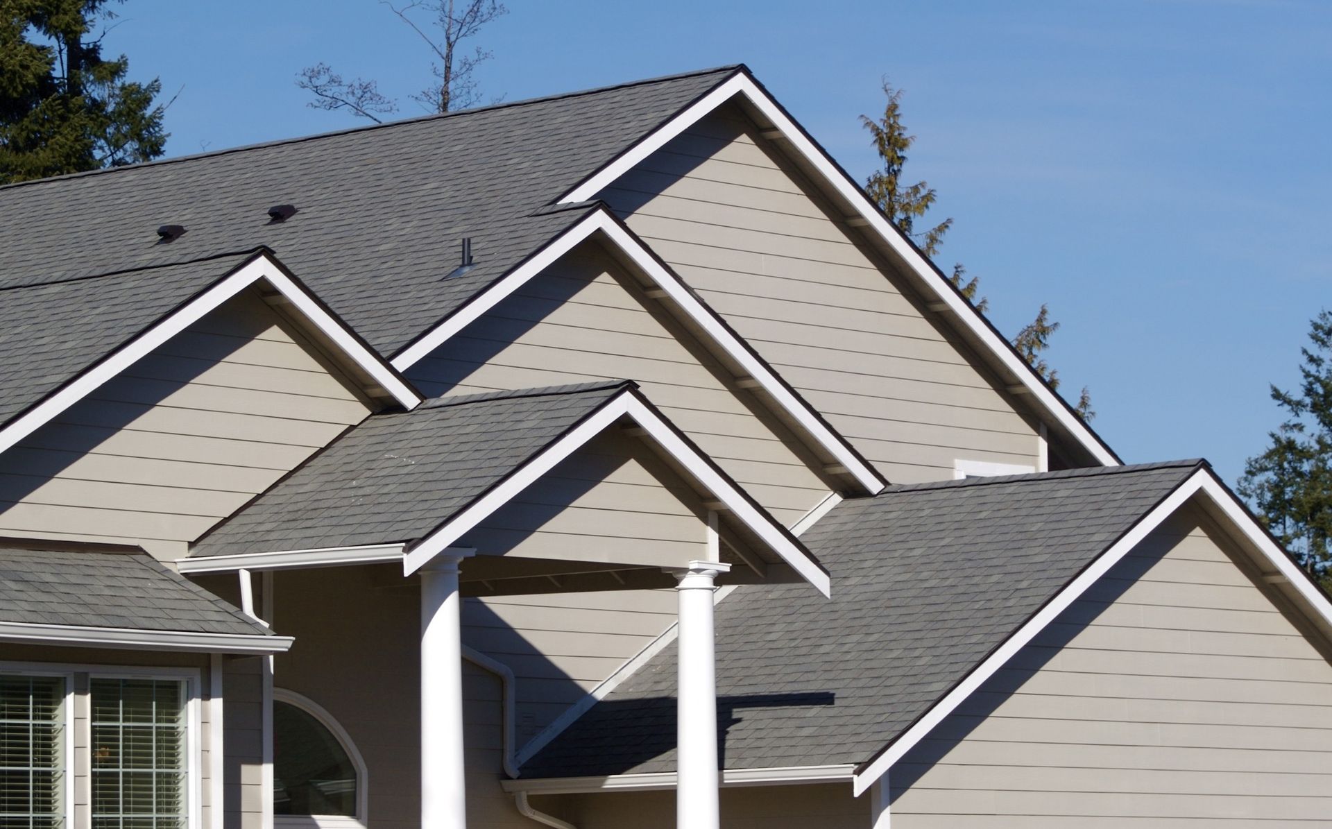 A house with a gray roof and white trim
