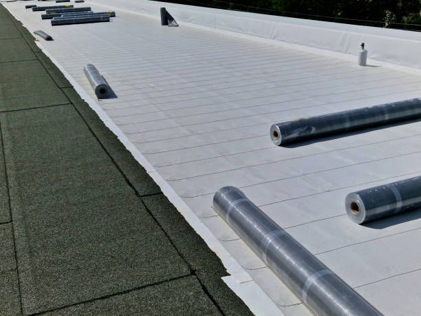 A white roof with rolls of asphalt on it