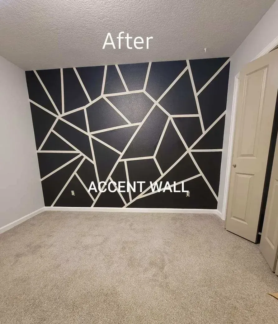 An empty room with a black accent wall