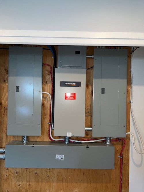 A bunch of electrical panels are hanging on a wall.