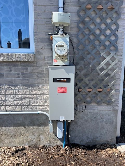 Electrical meter and service box mounted on a brick house exterior, with conduit and gravel below