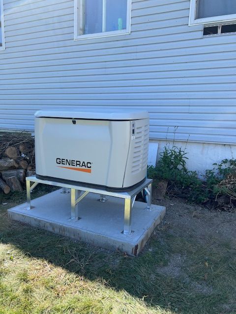 Generac home standby generator on a concrete pad beside a house