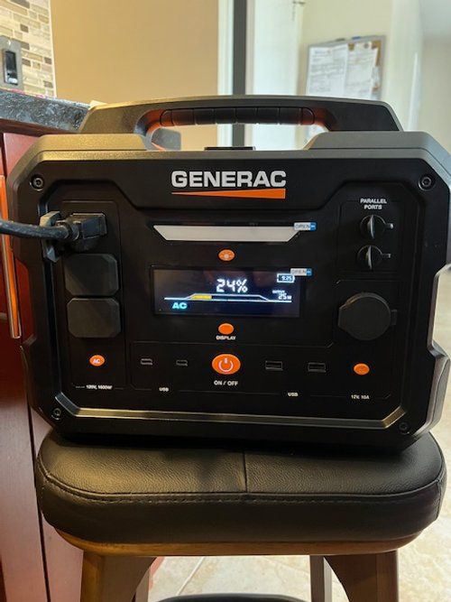 A generator is sitting on a stool in a kitchen.