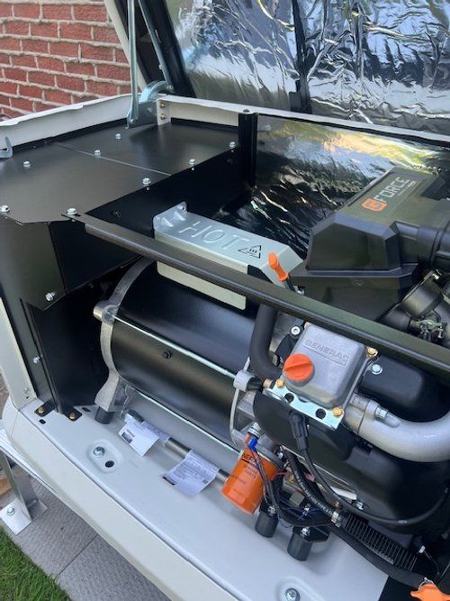 A close up of the inside of a generator with the hood open.