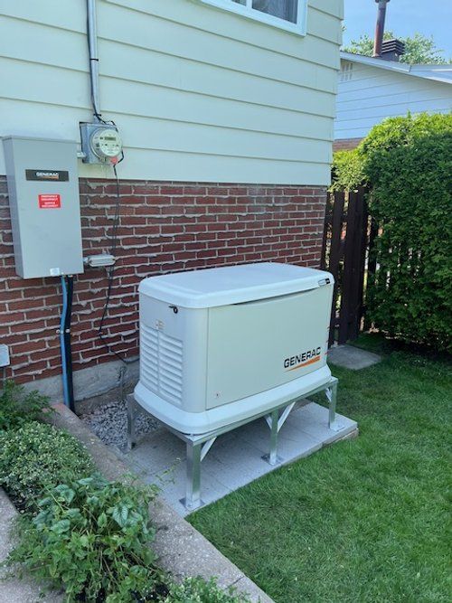 A generator is sitting on the side of a house.