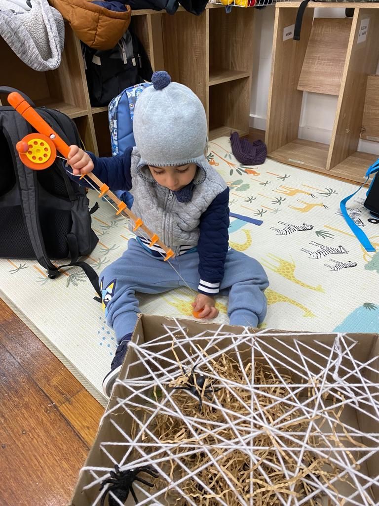 a child playing with a toy fishing rod