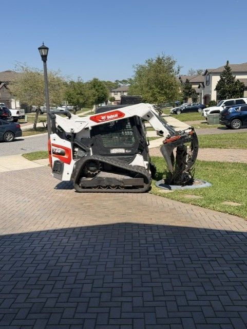 Damaged white and red utility vehicle overturned on a sidewalk in a suburban neighborhood.