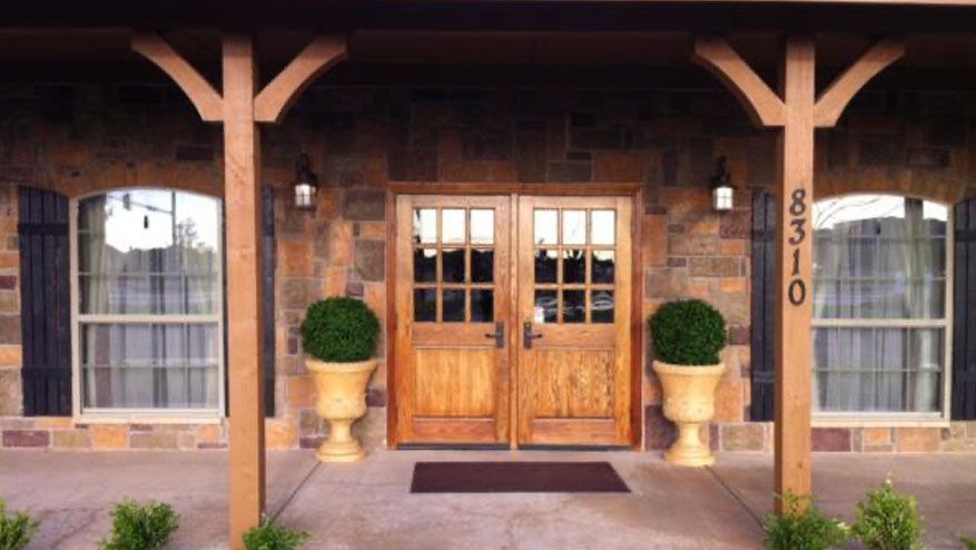 a house with a porch and a wooden door