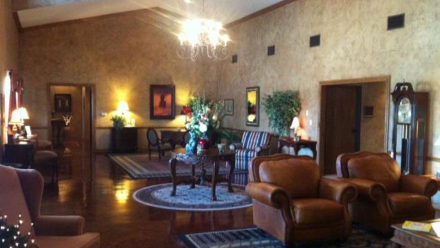a living room filled with furniture and a clock