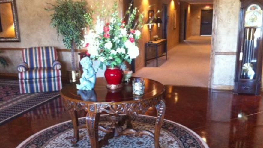 a round table with a vase of flowers on it