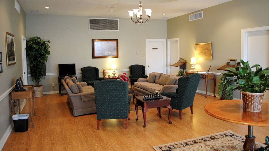 a living room filled with furniture and a chandelier