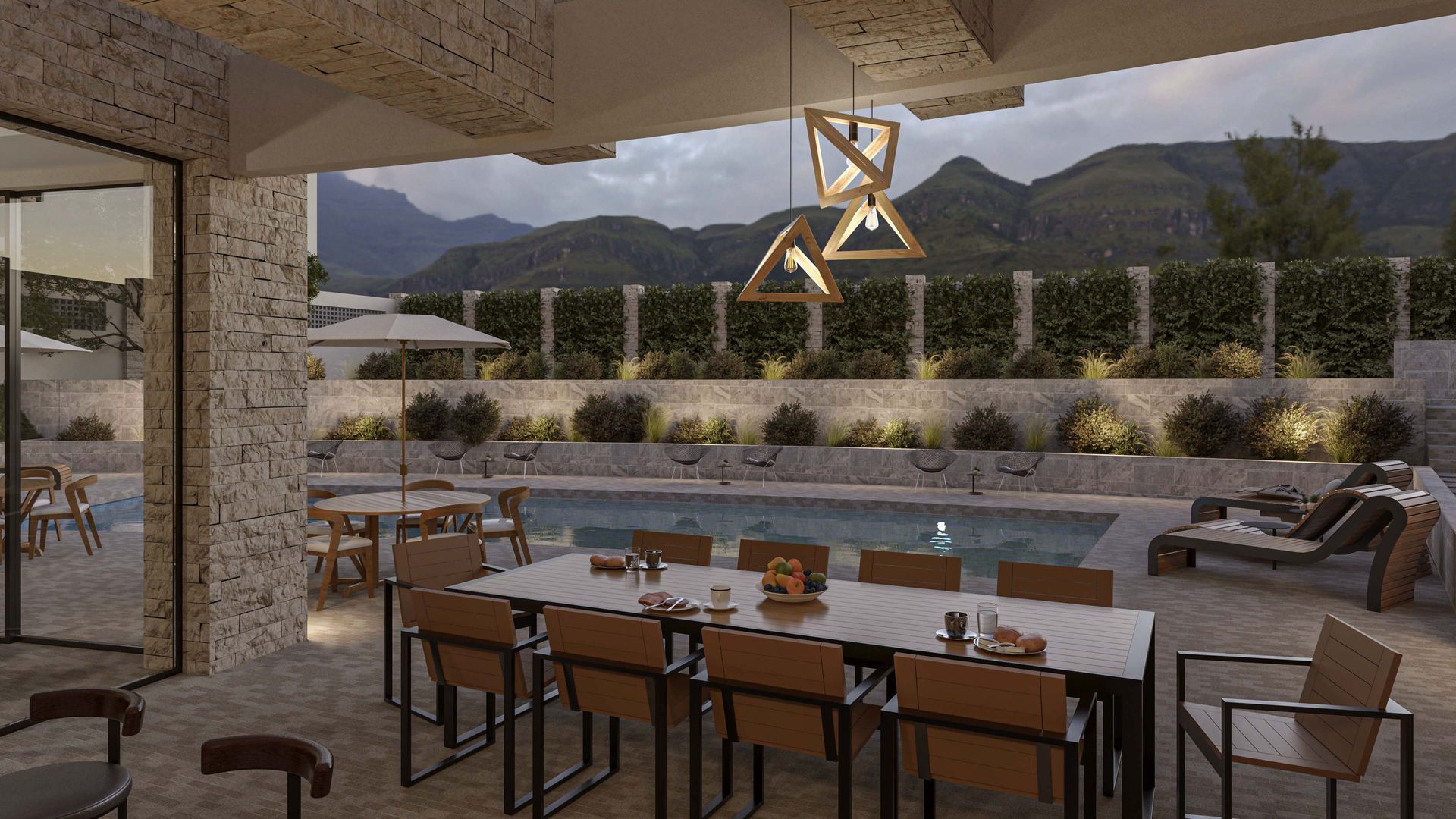 Terraza al aire libre con comedor, mesas, sillas y vistas a la montaña al atardecer.