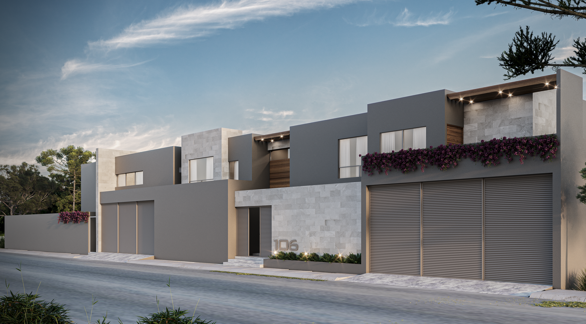 Exterior casa guadalquivir con paredes blancas, puertas de cristal, balcones y enredaderas de flores rosas