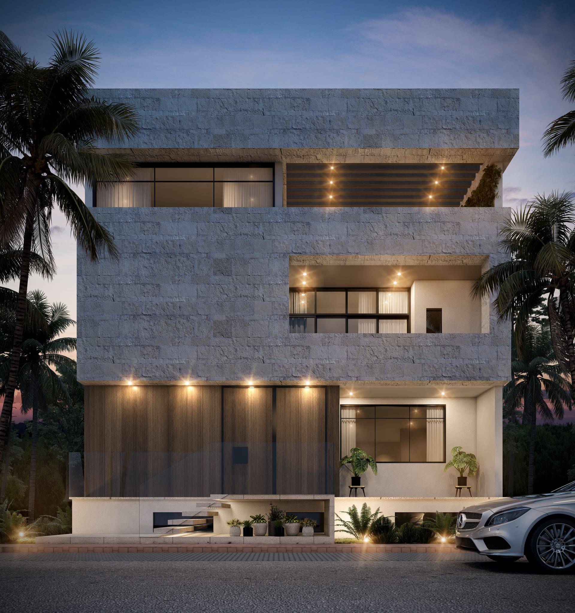 Exterior de una casa moderna de tres plantas al atardecer, con fachada de piedra, luces cálidas y un coche aparcado delante.