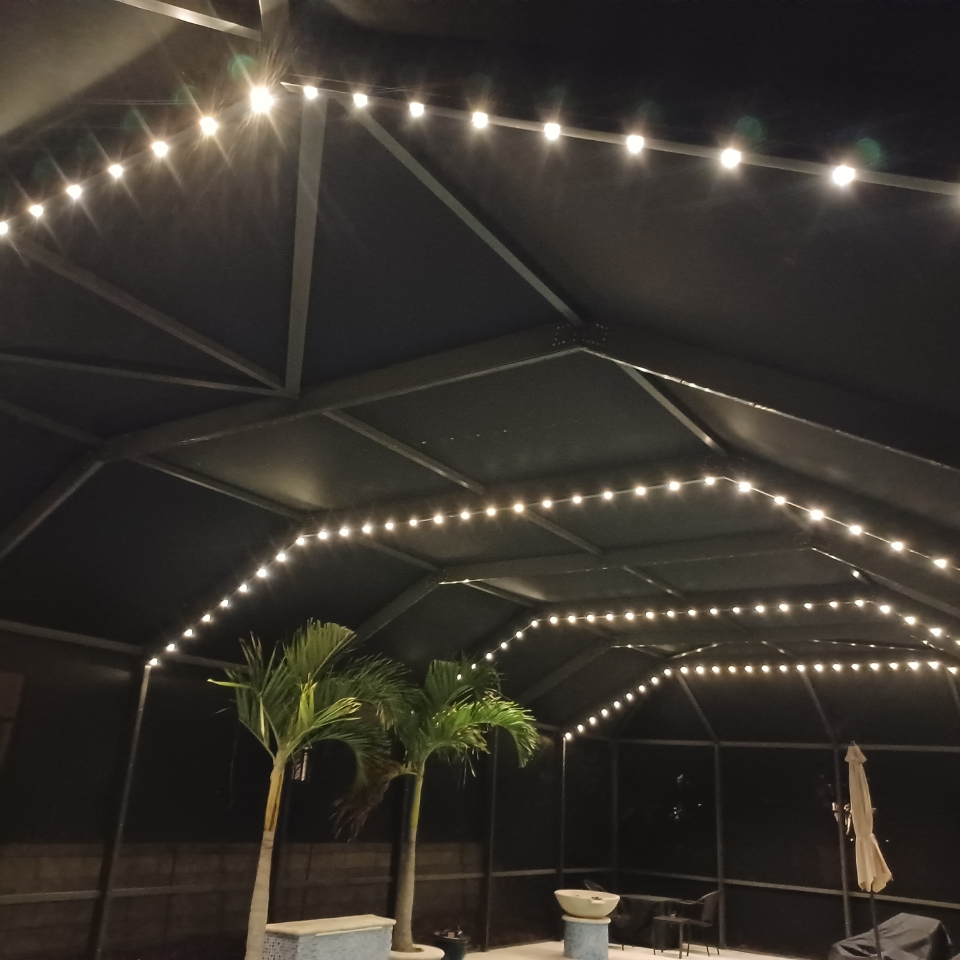 A gazebo with a string of lights hanging from the ceiling