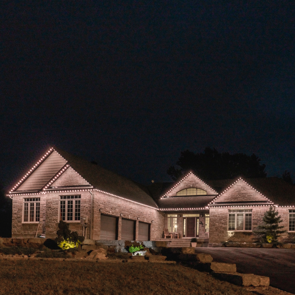 A house is lit up with pink lights at night