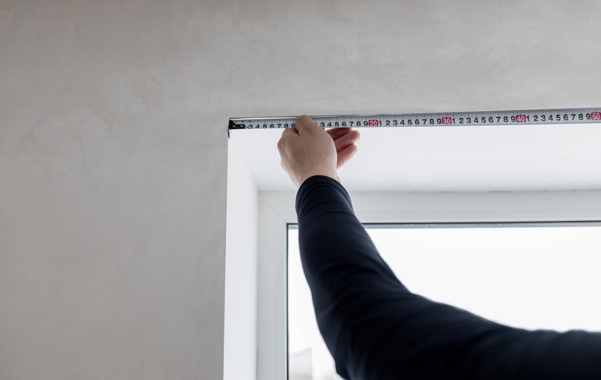 Window Treatment Professional Measuring the Inside of a Window