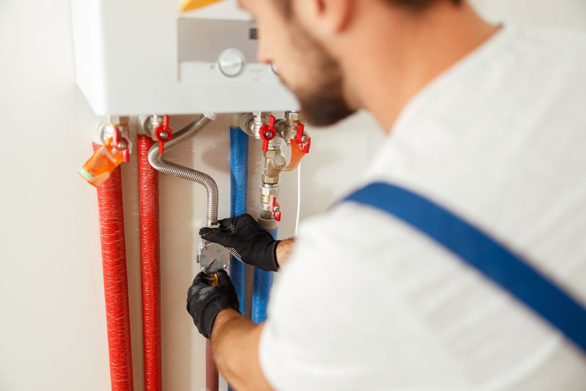 Man flushing a tankless water heater