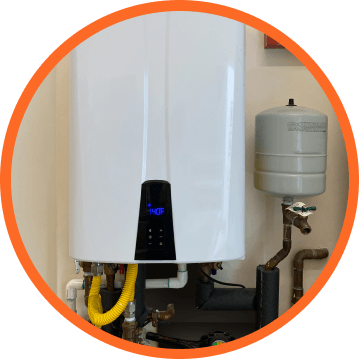 White water heater with digital display, attached to pipes, in a room.