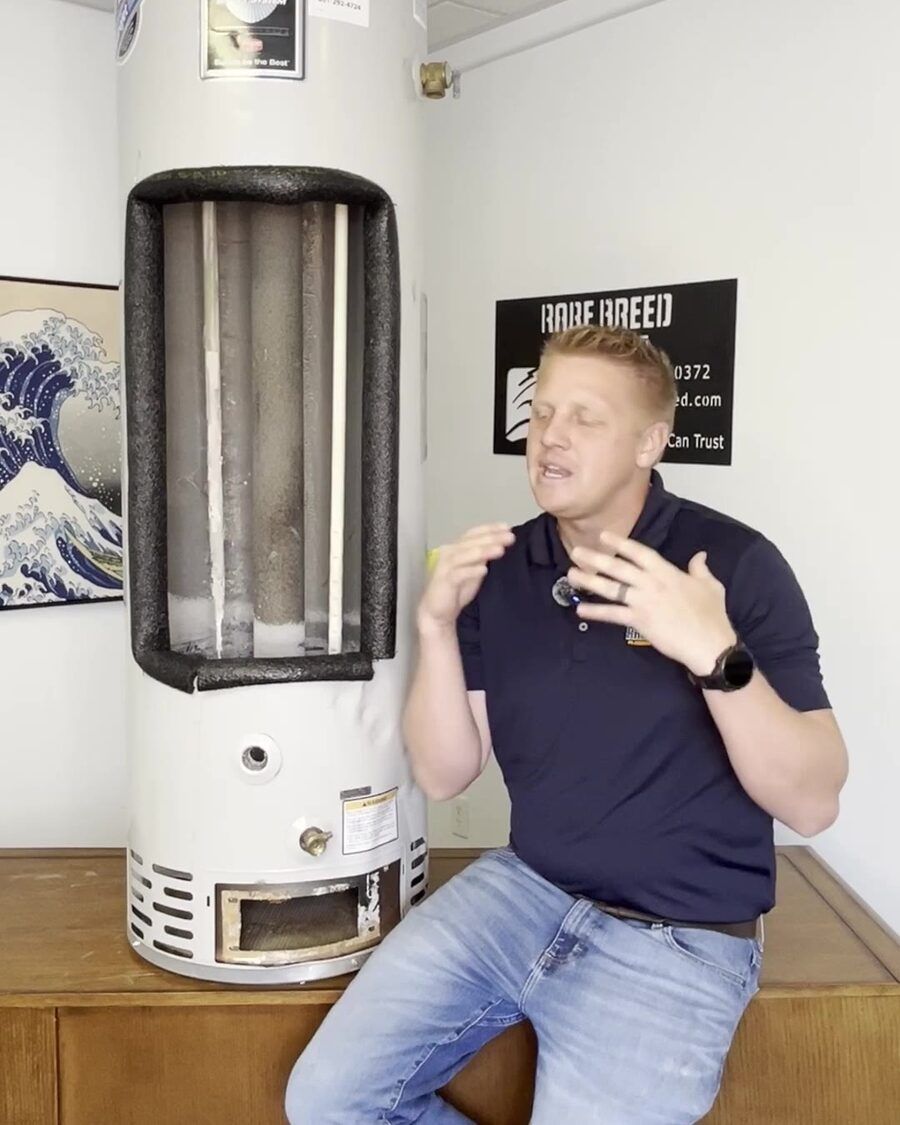 Court Lundberg explains water heater failure warning signs next to a cutaway tank showing the interi
