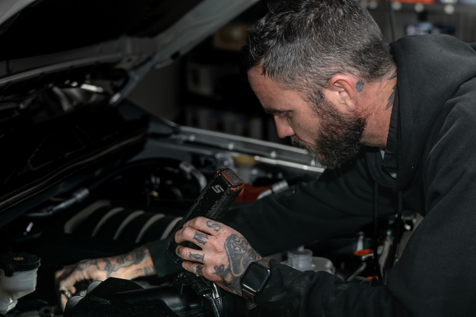 Mechanic inspecting a car engine