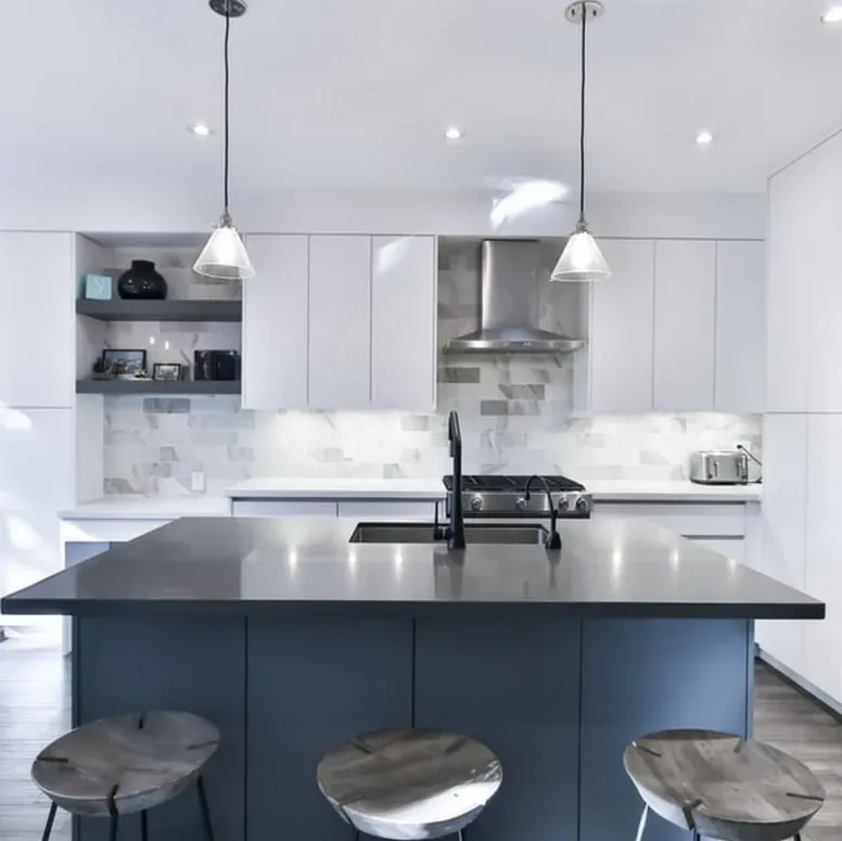 A kitchen with a large island and stools