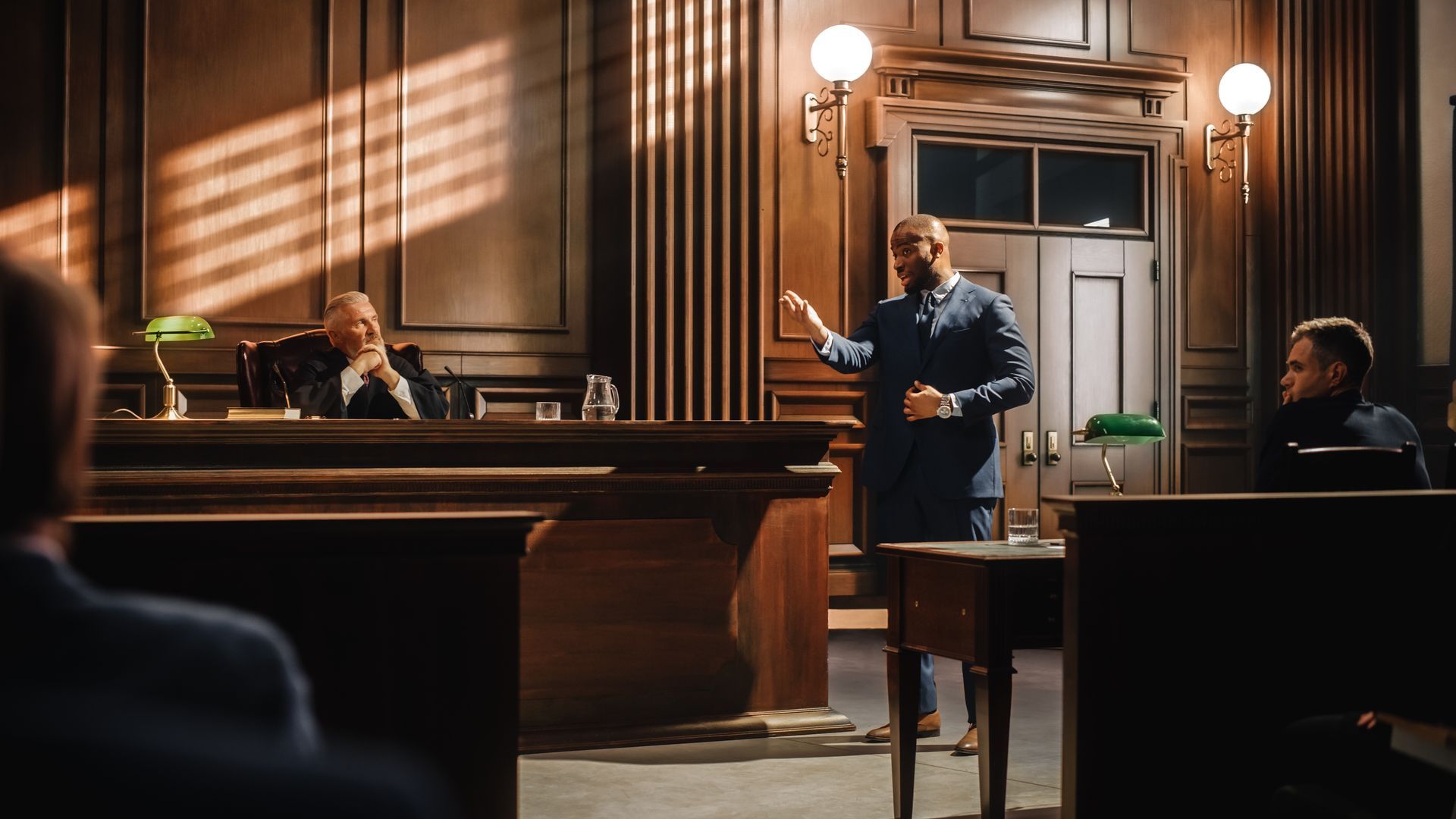 A man speaking in front of a judge in a courtroom