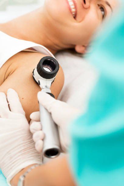 Patient laying while getting a dermoscopy on arm