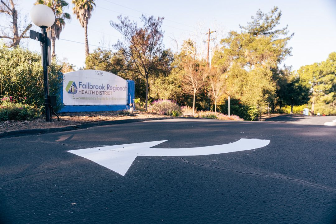 A white arrow is painted on the side of a road.