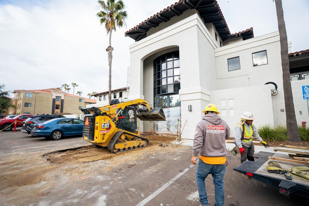 A group of construction workers are standing in front of a building.